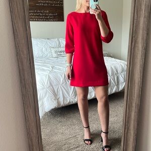 Red mini dress with low back and a bow.